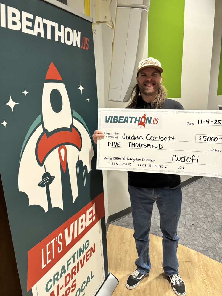 Jordan Corbett holding the first-place check at the Vibeathon